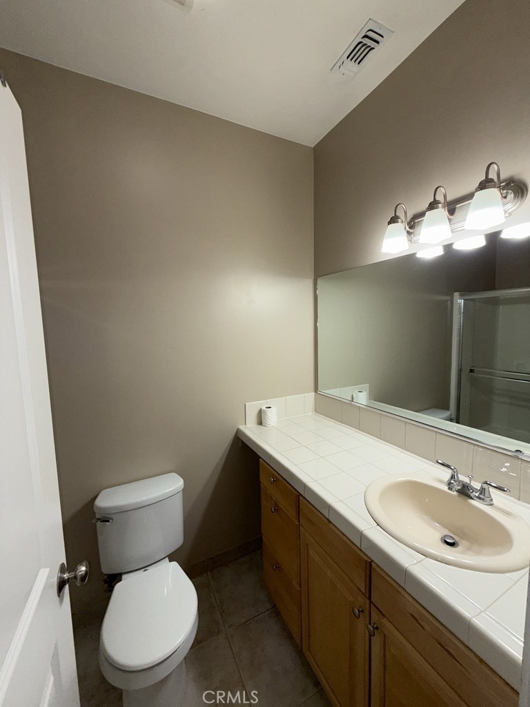 10401 Point Lakeview Road, Unit A Kelseyville, CA 95451 - Photo 14 of 17 a bathroom with a toilet sink vanity granite and mirror