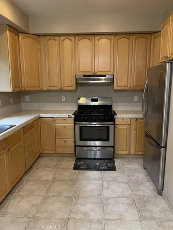 a kitchen with a stove sink and cabinets