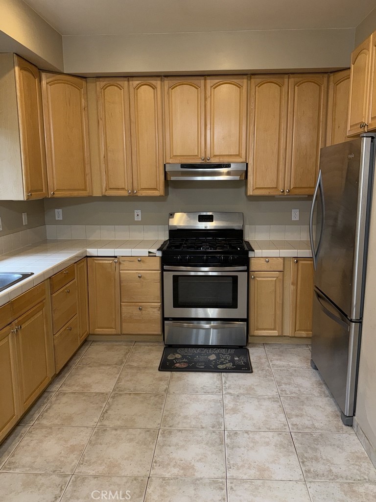 10401 Point Lakeview Road, Unit A Kelseyville, CA 95451 - Photo 5 of 17 a kitchen with a stove sink and cabinets