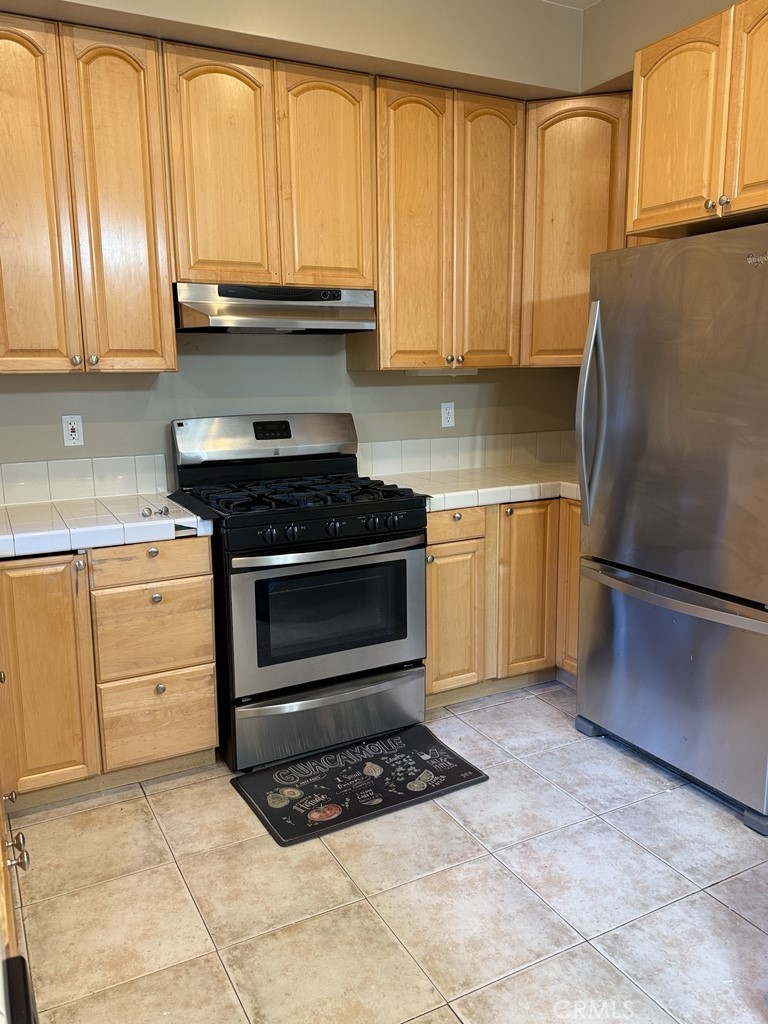 10401 Point Lakeview Road, Unit A Kelseyville, CA 95451 - Photo 6 of 17 a kitchen with granite countertop a stove a sink and a refrigerator