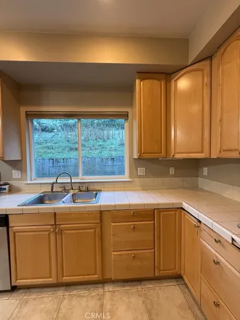 a kitchen with sink cabinets and window