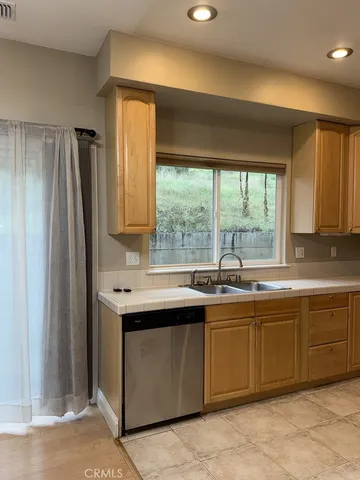 a kitchen with a sink and large window