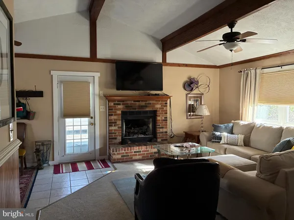 a living room with furniture fireplace and a flat screen tv
