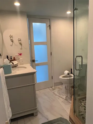 a bathroom with a shower and toilet