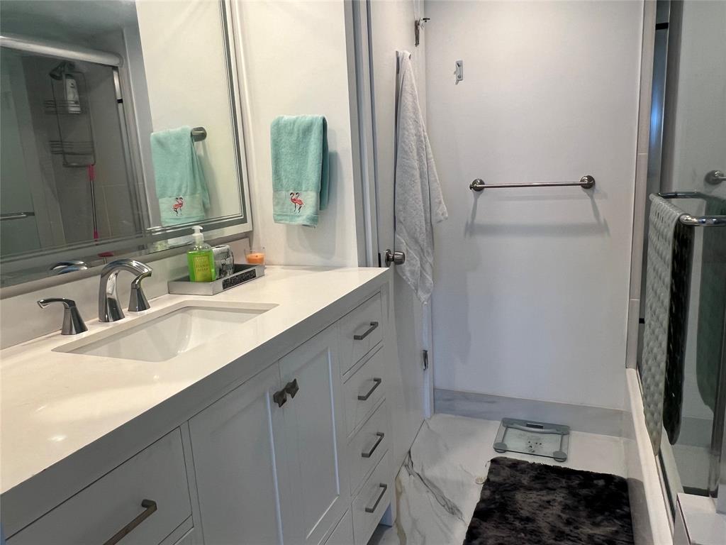 1610 North Ocean Boulevard, Unit 1202 Pompano Beach, FL 33062 - Photo 14 of 31 a bathroom with a double vanity sink and a mirror