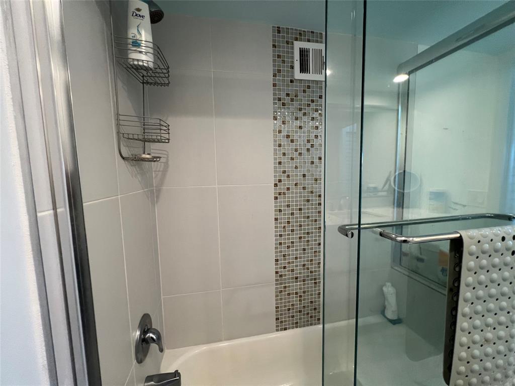 1610 North Ocean Boulevard, Unit 1202 Pompano Beach, FL 33062 - Photo 15 of 31 a bathroom with a shower and toilet