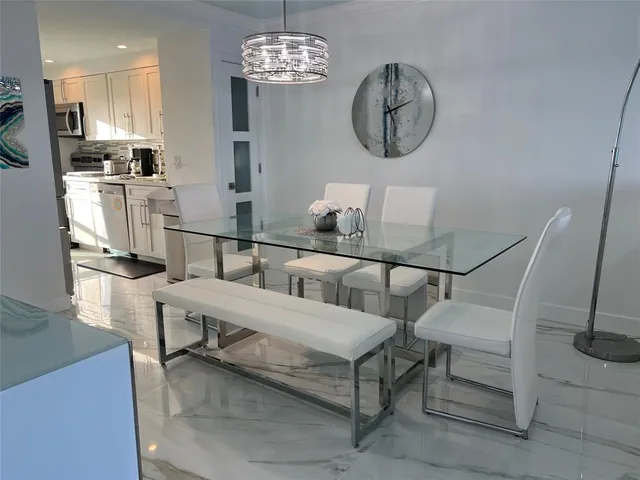 a kitchen with stainless steel appliances a stove a refrigerator and a sink