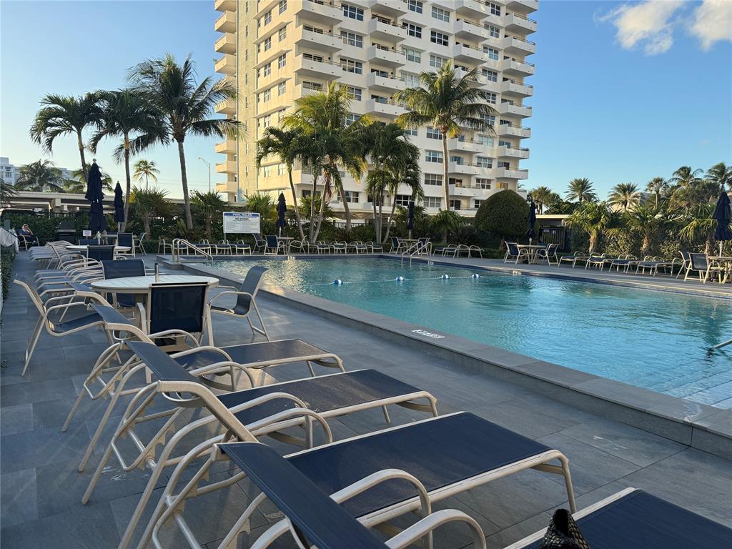 1610 North Ocean Boulevard, Unit 1202 Pompano Beach, FL 33062 - Photo 25 of 31 a view of a swimming pool with outdoor seating and lake view