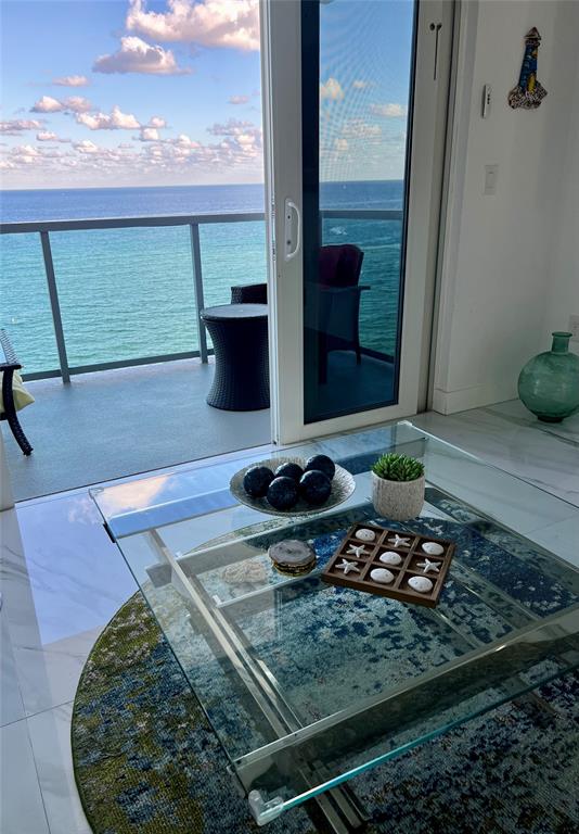 1610 North Ocean Boulevard, Unit 1202 Pompano Beach, FL 33062 - Photo 4 of 31 a view of a balcony with chair and glass door