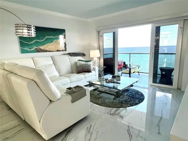 a living room with furniture a rug and a chandelier