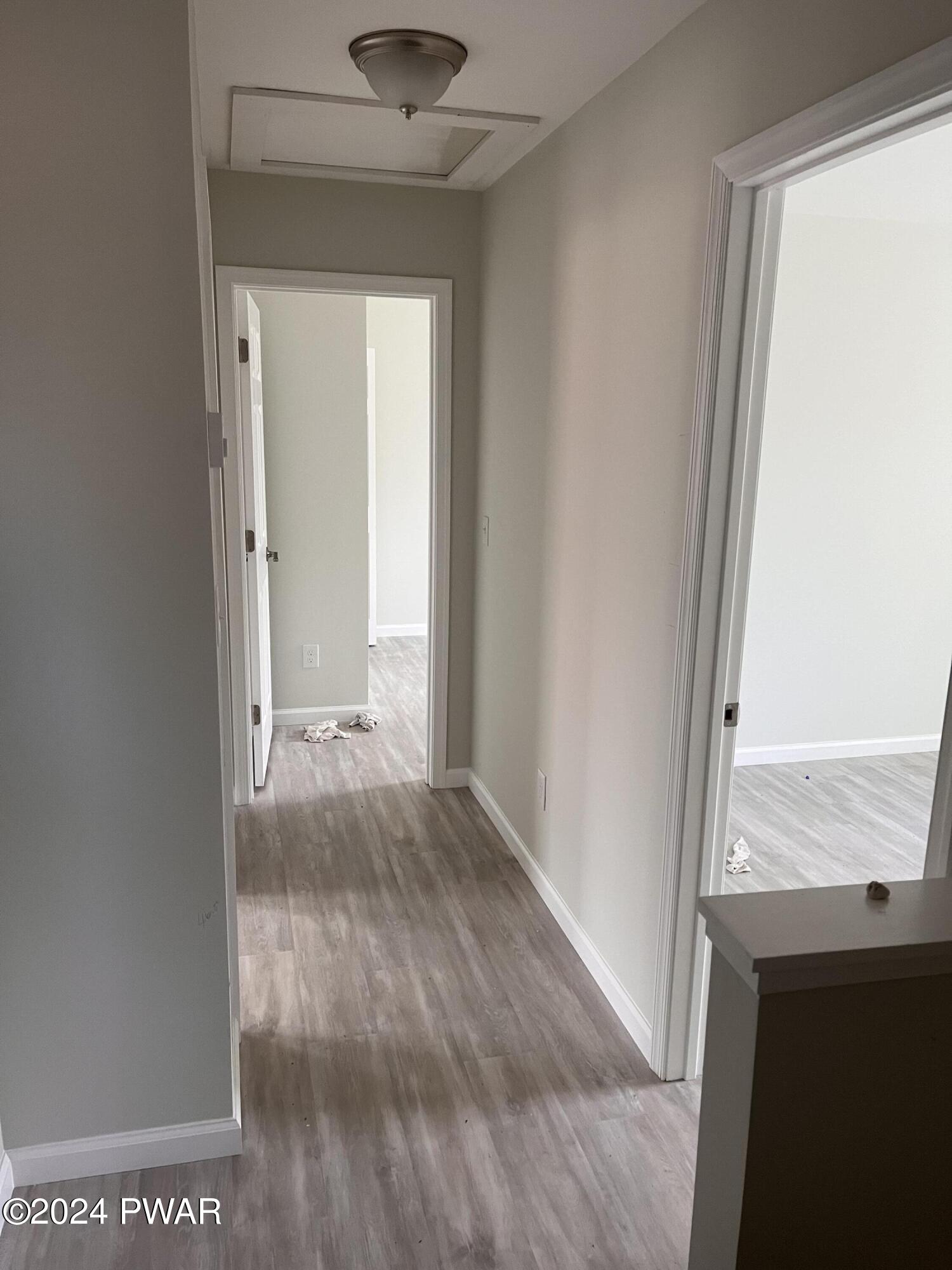 128 Stonehenge Road Milford, PA 18337 - Photo 9 of 14 a view of a hallway with wooden floor and a window
