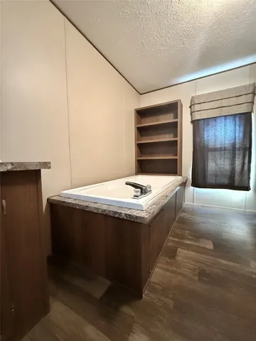 a view of spacious kitchen with a sink