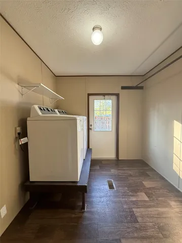 a view of a room with wooden floor and window