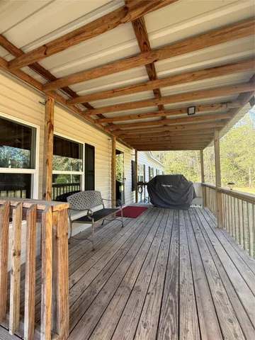 a view of living room with wooden floor and furniture