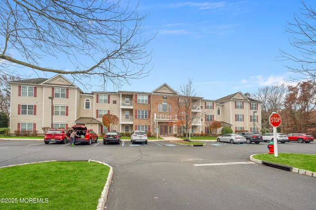 a living room with furniture and large windows