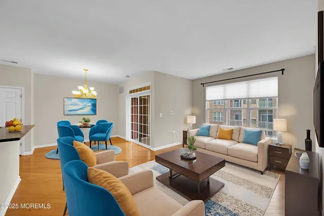 a view of a dining room with furniture and a book shelf