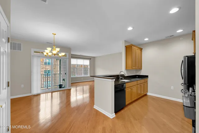 a sign board with a house in the background