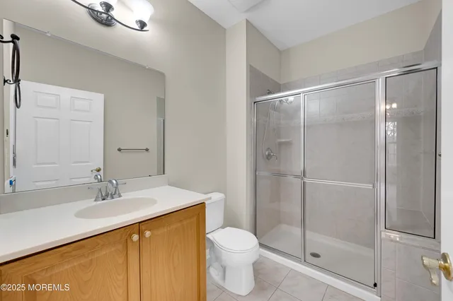 a front view of a house with a garden and parking space