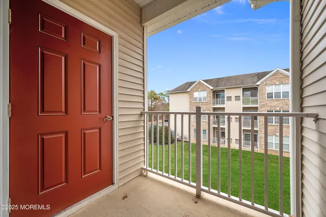 a bedroom with bed and a large window