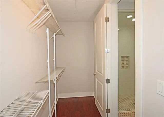 a bathroom with a granite countertop sink and white cabinets