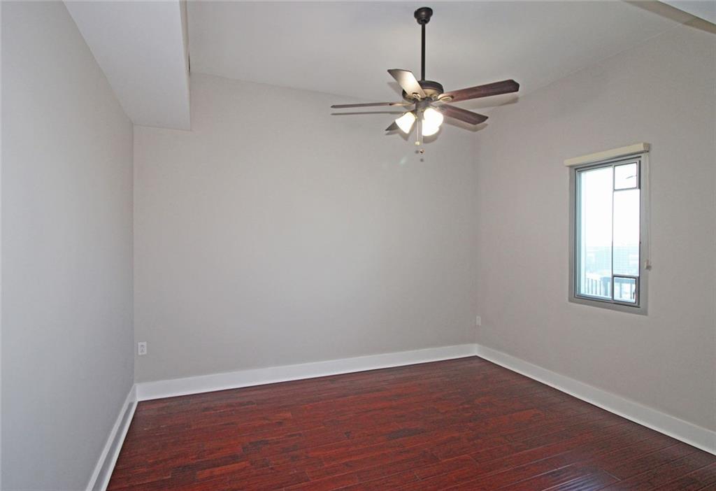 4561 Olde Perimeter Way, Unit 2102 Atlanta, GA 30346 - Photo 17 of 44 wooden floor in an empty room with a window