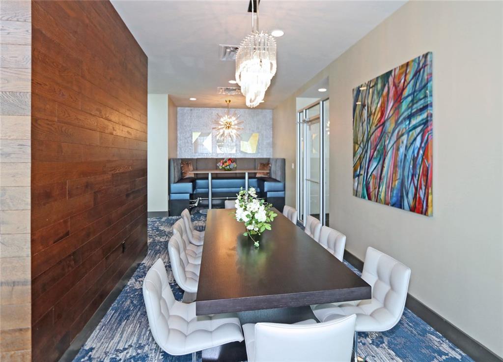 4561 Olde Perimeter Way, Unit 2102 Atlanta, GA 30346 - Photo 26 of 44 a view of a dining room with furniture and chandelier