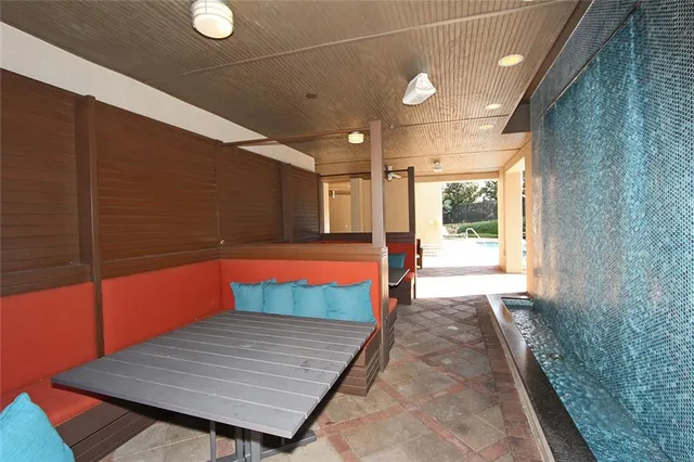 a view of a patio with a dining table and chairs under an umbrella