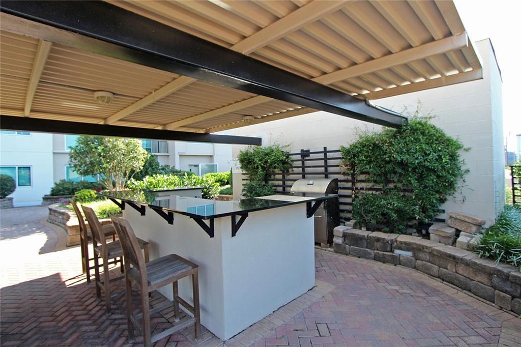 4561 Olde Perimeter Way, Unit 2102 Atlanta, GA 30346 - Photo 38 of 44 a outdoor dining space with furniture and outdoor view