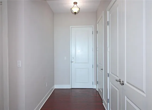 a view of a hallway with wooden floor