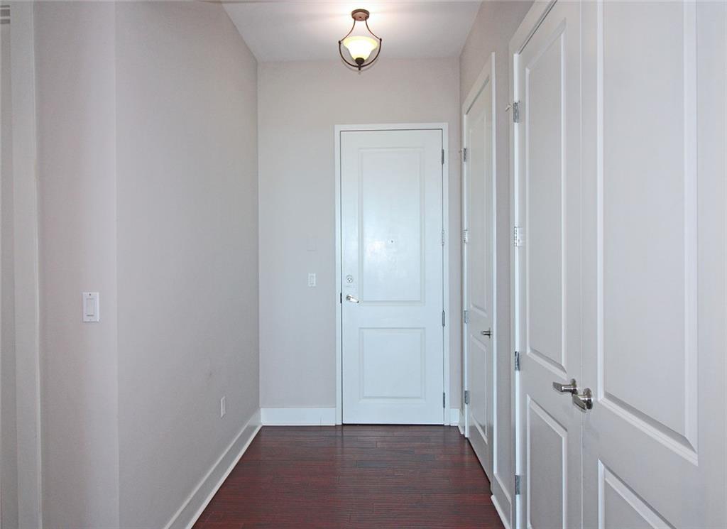 4561 Olde Perimeter Way, Unit 2102 Atlanta, GA 30346 - Photo 4 of 44 a view of a hallway with wooden floor