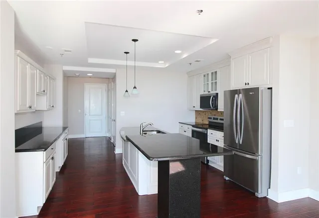 a kitchen with stainless steel appliances a refrigerator stove microwave and cabinets