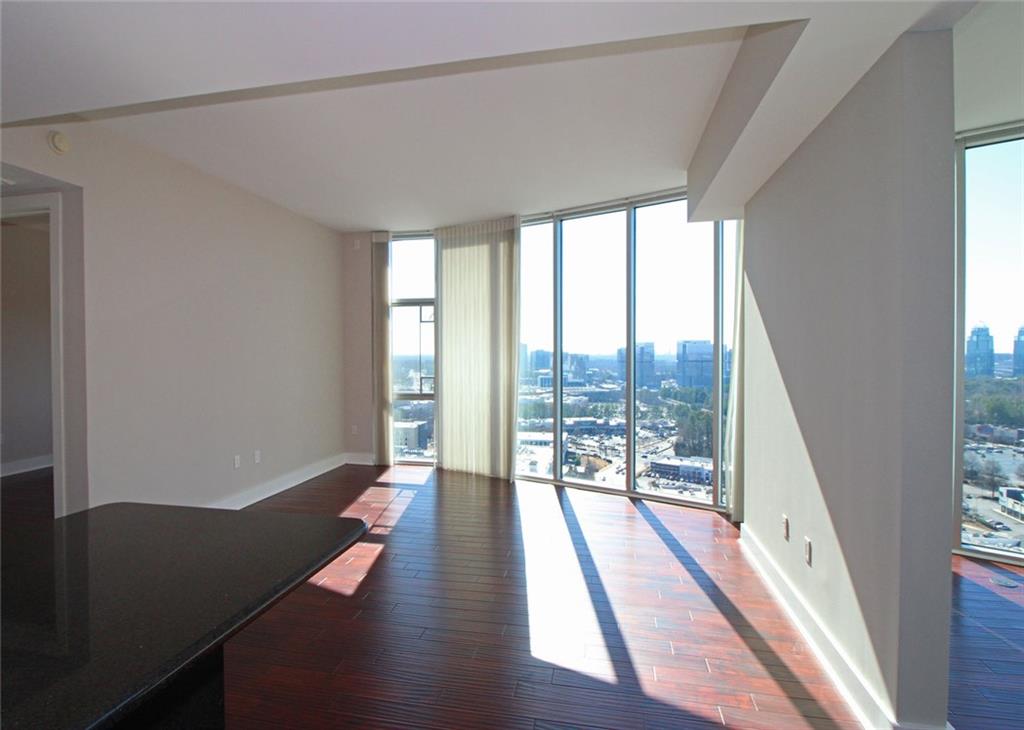 4561 Olde Perimeter Way, Unit 2102 Atlanta, GA 30346 - Photo 6 of 44 a view of a room with wooden floor and chair