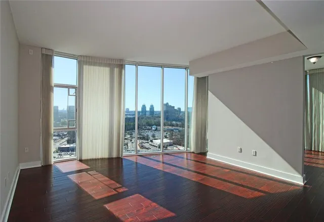 a view of a room with wooden floor and windows