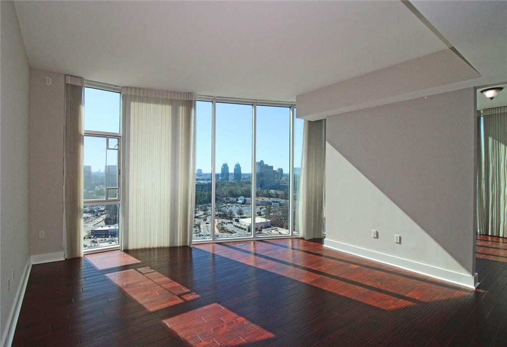 4561 Olde Perimeter Way, Unit 2102 Atlanta, GA 30346 - Photo 7 of 44 a view of a room with wooden floor and windows