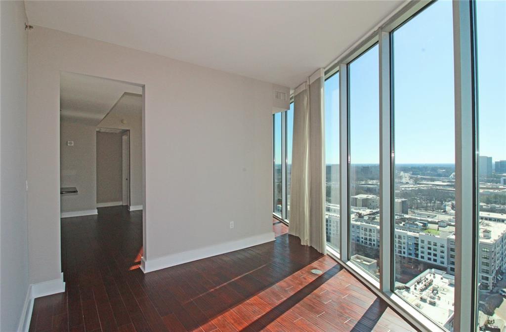 4561 Olde Perimeter Way, Unit 2102 Atlanta, GA 30346 - Photo 10 of 44 a view of room with floor to ceiling windows and wooden floor