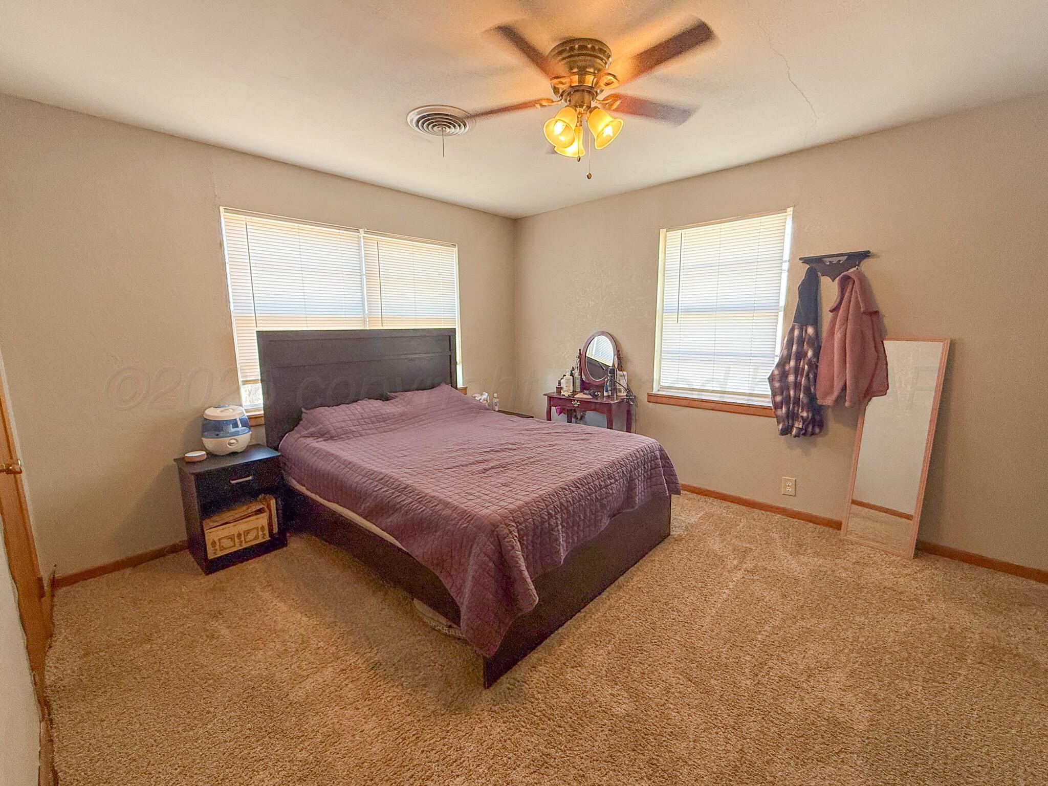 702 South Canadian Street Wheeler, TX 79096 - Photo 30 of 47 a bedroom with a bed dresser and a window