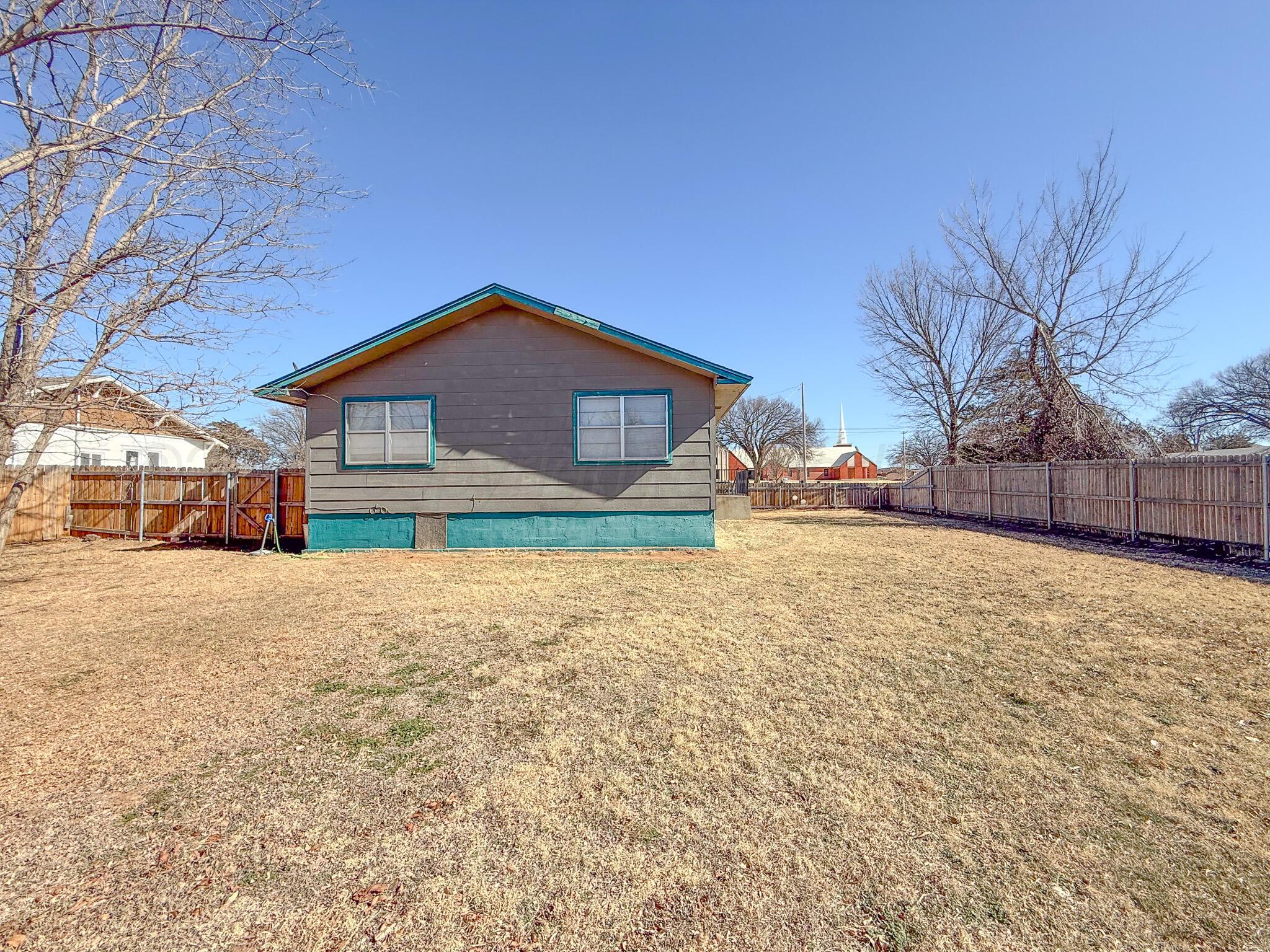 702 South Canadian Street Wheeler, TX 79096 - Photo 39 of 47 a front view of a house with a yard