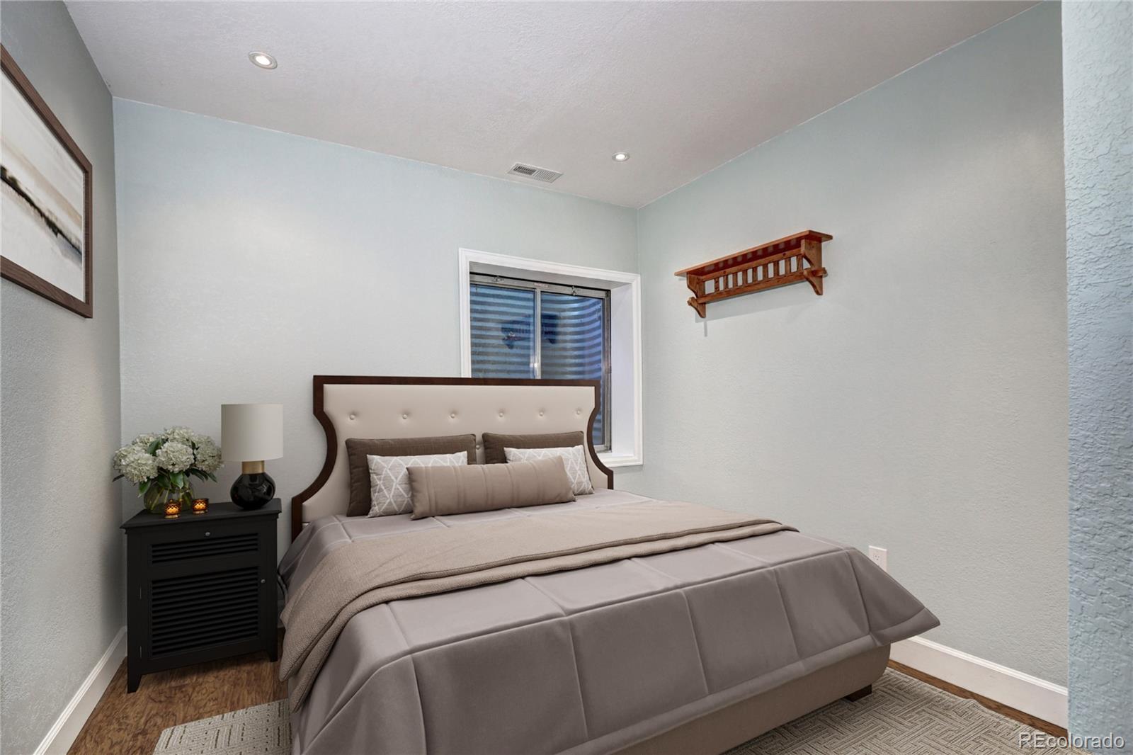 1313 Iris Circle Broomfield, CO 80020 - Photo 18 of 41 a bedroom with a bed and a potted plant