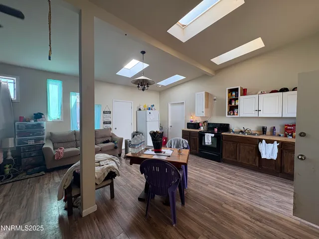 a living room with furniture and kitchen view