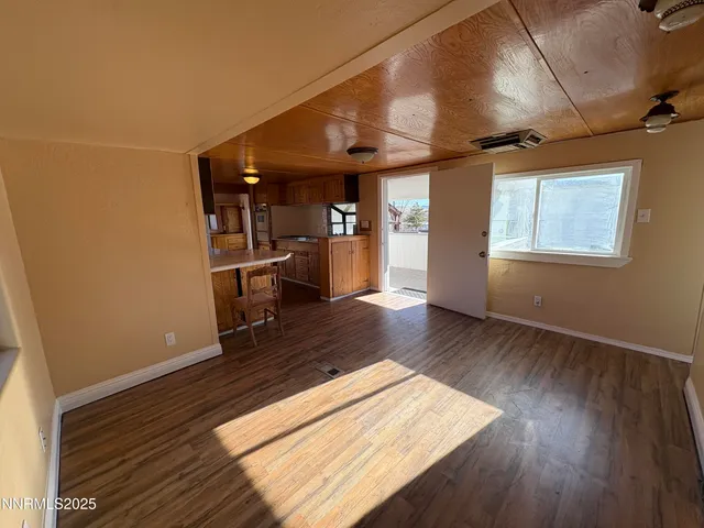 a view of a living room with wooden floor