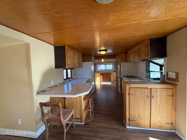 a kitchen with a sink cabinets and wooden floor