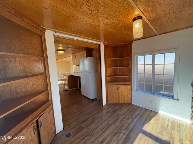 a view of an empty room and wooden floor