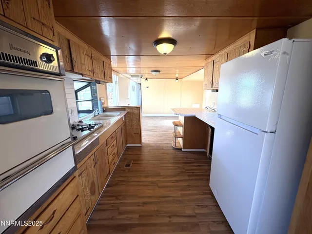 a kitchen with stainless steel appliances a refrigerator and a stove