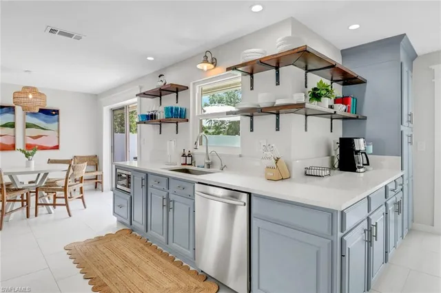 a kitchen with stainless steel appliances a sink and a refrigerator