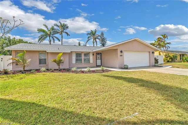 a front view of house with yard and outdoor seating
