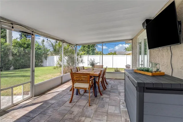 a outdoor living space with patio furniture and a flat screen tv