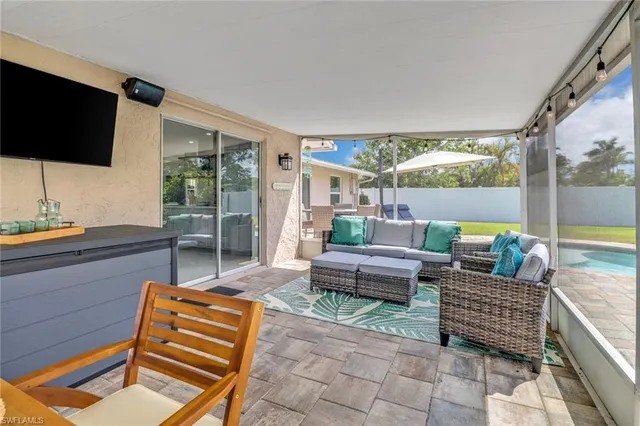 a living room with a large window and a flat screen tv