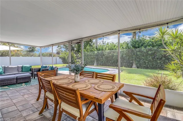 a outdoor dining space with furniture and garden view
