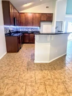 a kitchen with stainless steel appliances granite countertop a sink stove and cabinets