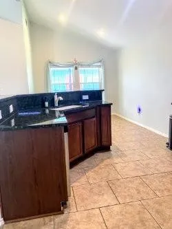 a kitchen with stainless steel appliances granite countertop a sink and cabinets